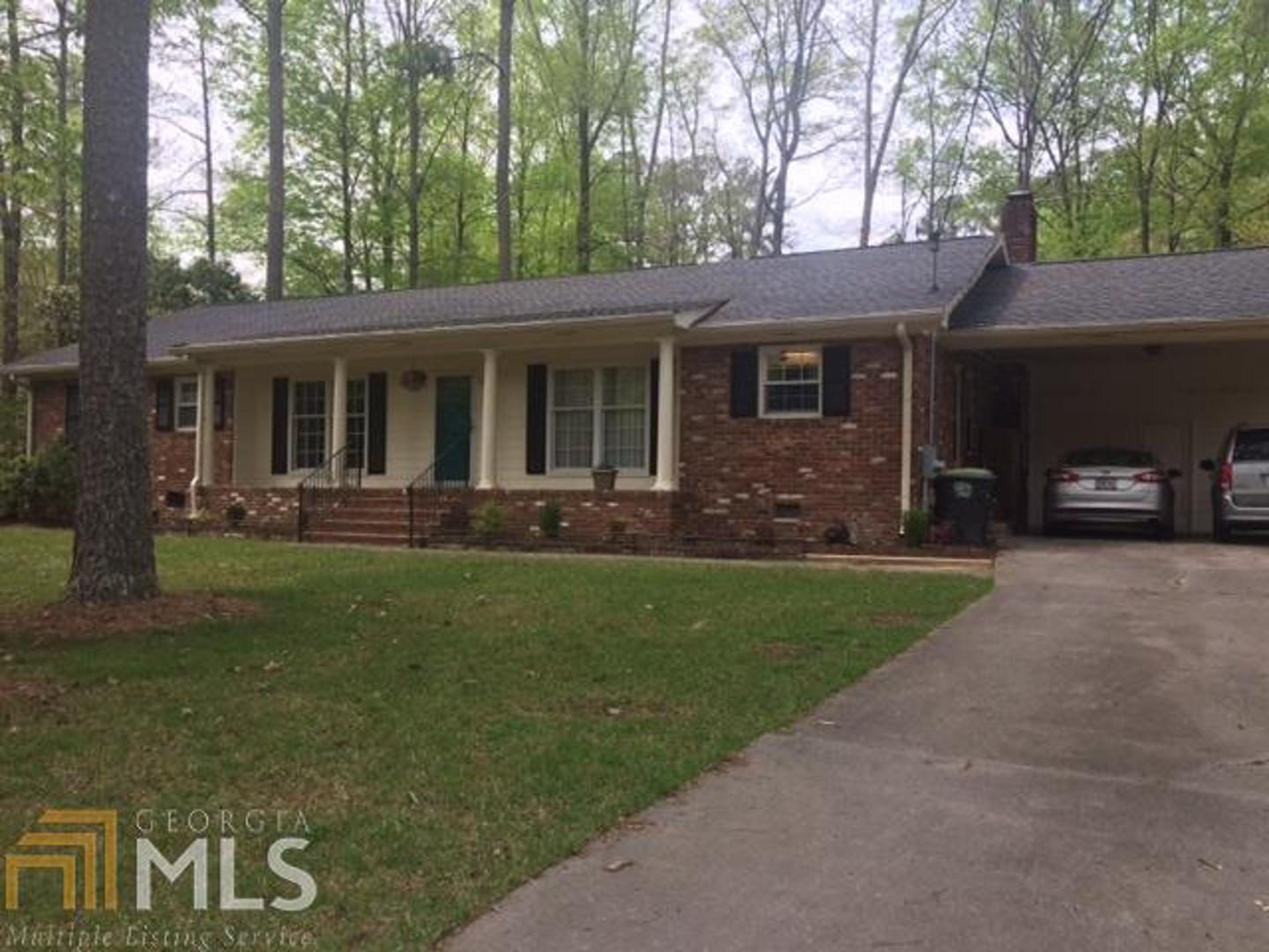 6 Arlington Court, Unit 5152 Rome, GA 30165 - Photo 1 of 1 a front view of a house with a garden and trees