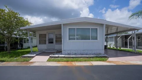 a front view of a house with a yard and porch