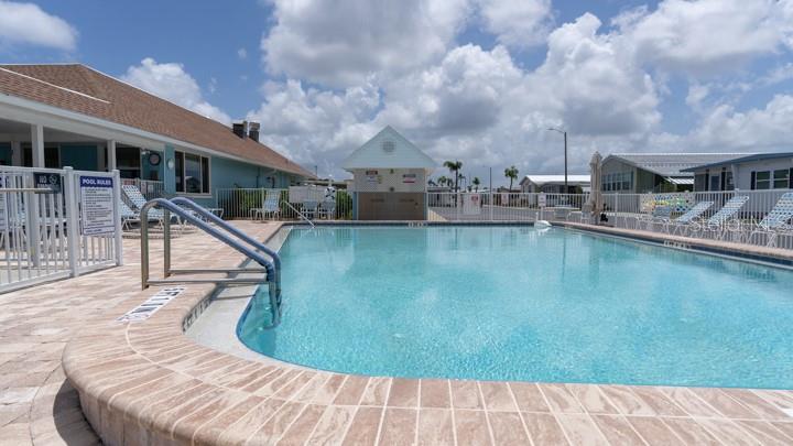 3301 Alt 19 Palm Harbor, Unit 317 Palm Harbor, FL 34683 - Photo 13 of 48 a view of a swimming pool with a patio