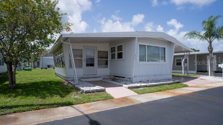 3301 Alt 19 Palm Harbor, Unit 317 Palm Harbor, FL 34683 - Photo 14 of 48 a front view of a house with a yard and garage