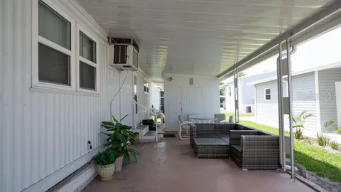 a view of backyard with potted plants and a large window