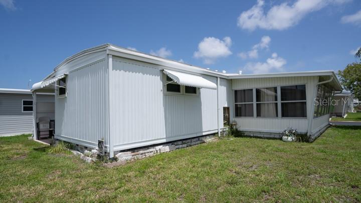 3301 Alt 19 Palm Harbor, Unit 317 Palm Harbor, FL 34683 - Photo 19 of 48 a view of backyard with potted plants and a large window