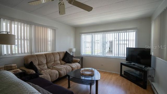 a living room with furniture and fireplace