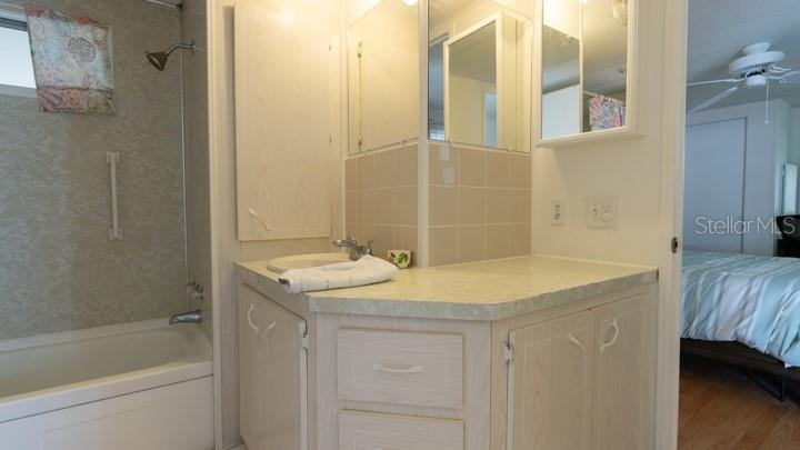 3301 Alt 19 Palm Harbor, Unit 317 Palm Harbor, FL 34683 - Photo 27 of 48 a bathroom with a granite countertop sink and a mirror