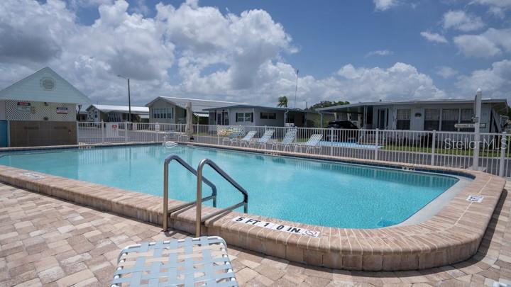 3301 Alt 19 Palm Harbor, Unit 317 Palm Harbor, FL 34683 - Photo 30 of 48 a view of a swimming pool with a patio