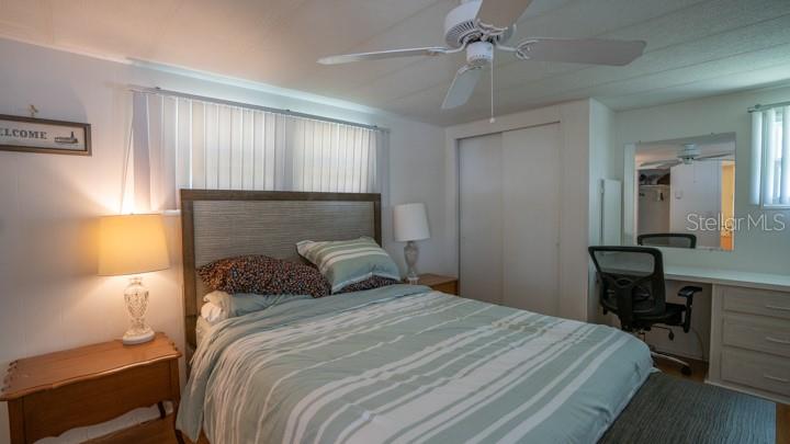 3301 Alt 19 Palm Harbor, Unit 317 Palm Harbor, FL 34683 - Photo 7 of 48 a bedroom with a bed and a table in it