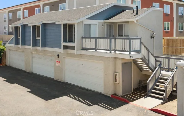 a view of a white house with many windows