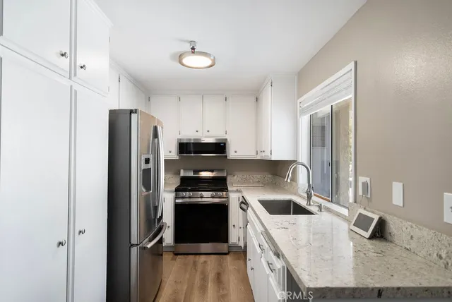 a kitchen with a refrigerator sink and stove