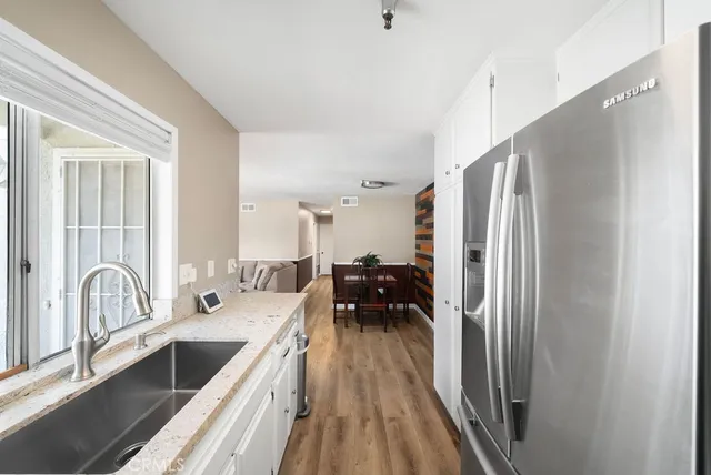 a kitchen with sink a refrigerator and furniture