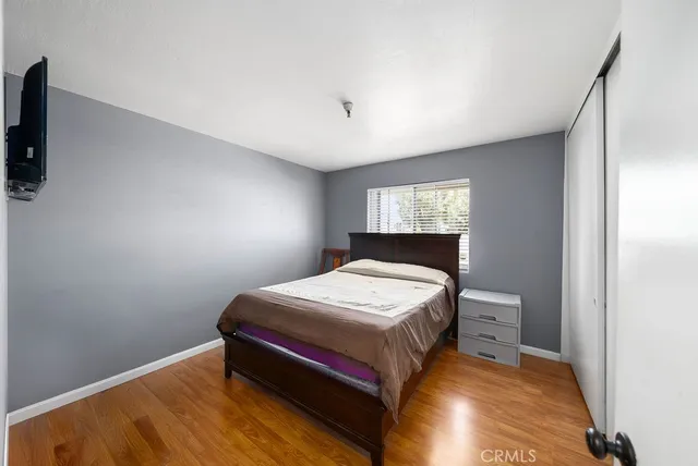 a bedroom with a bed and window