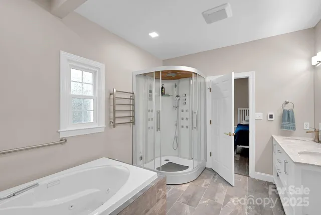 a bathroom with a glass shower door and a mirror