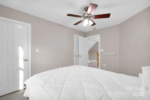 a spacious bedroom with a bed and a chandelier