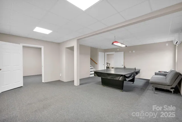 a living room with furniture a table and a large window