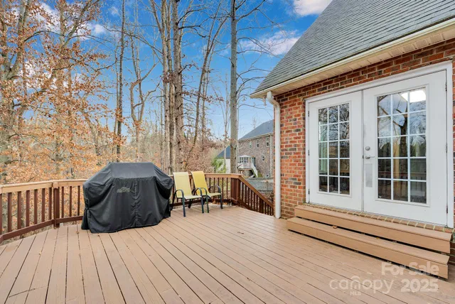a aerial view of a house with a yard and large trees