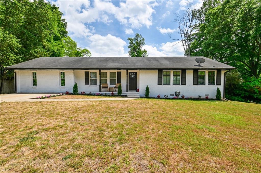 150 Sims Street Winder, GA 30680 - Photo 8 of 61 a front view of a house with a garden