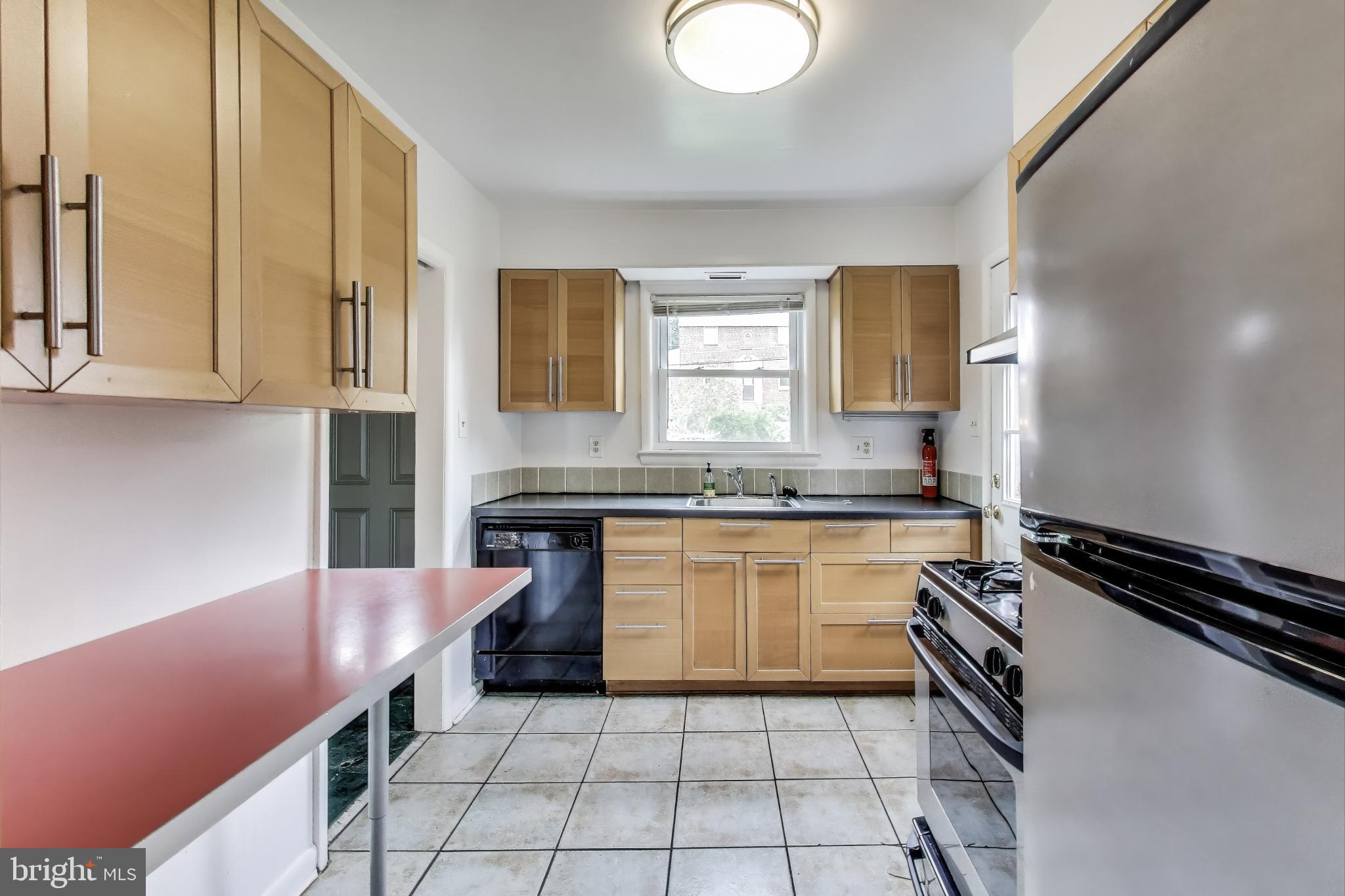 10019 Greenock Road Silver Spring, MD 20901 - Photo 12 of 39 a kitchen with a sink cabinets and appliances