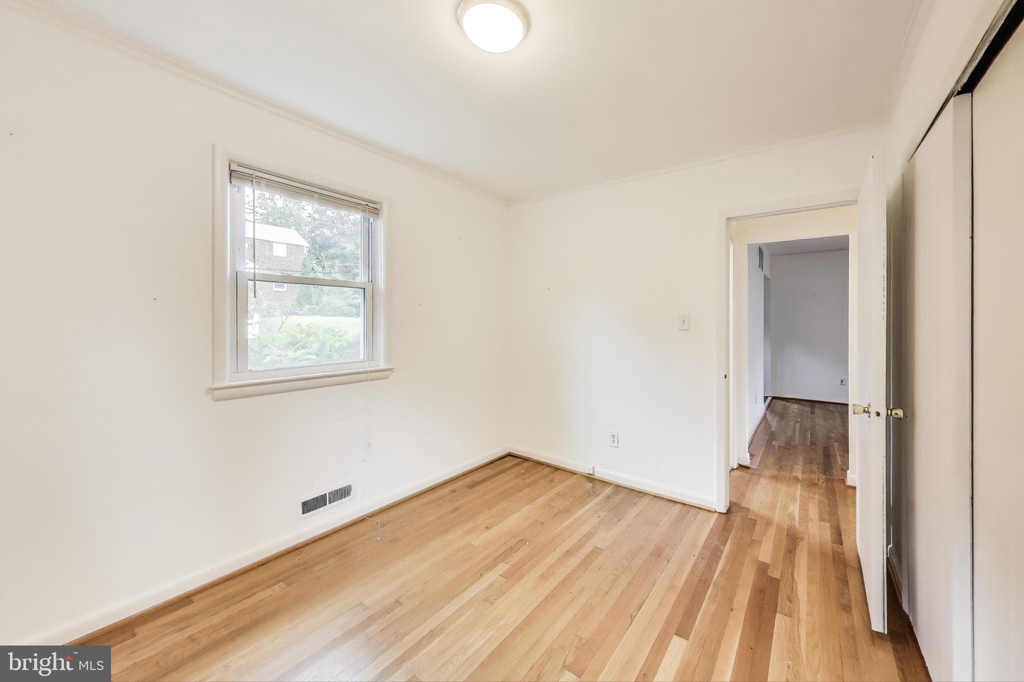 10019 Greenock Road Silver Spring, MD 20901 - Photo 17 of 39 an empty room with wooden floor and windows