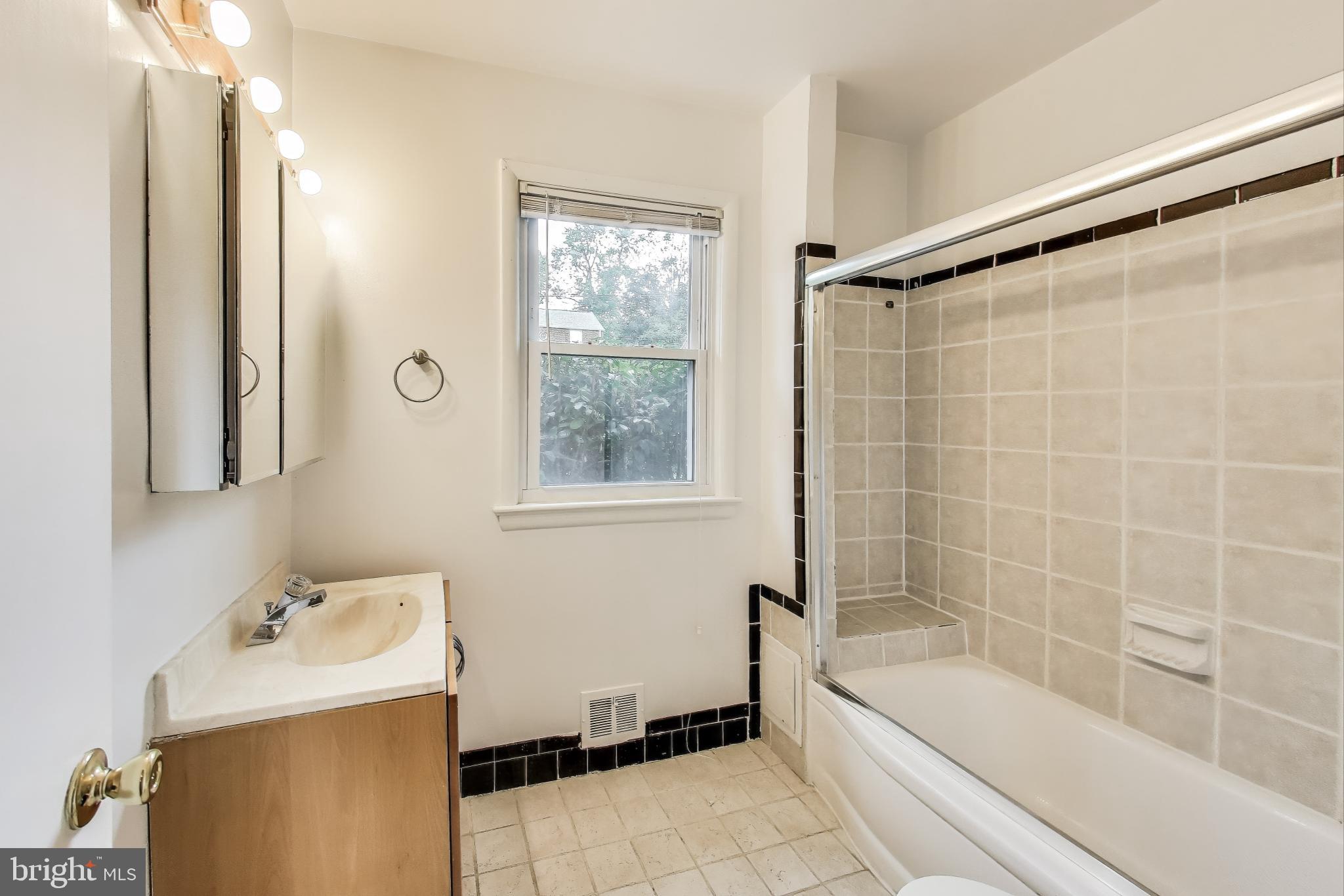 10019 Greenock Road Silver Spring, MD 20901 - Photo 18 of 39 a bathroom with a tub sink and mirror