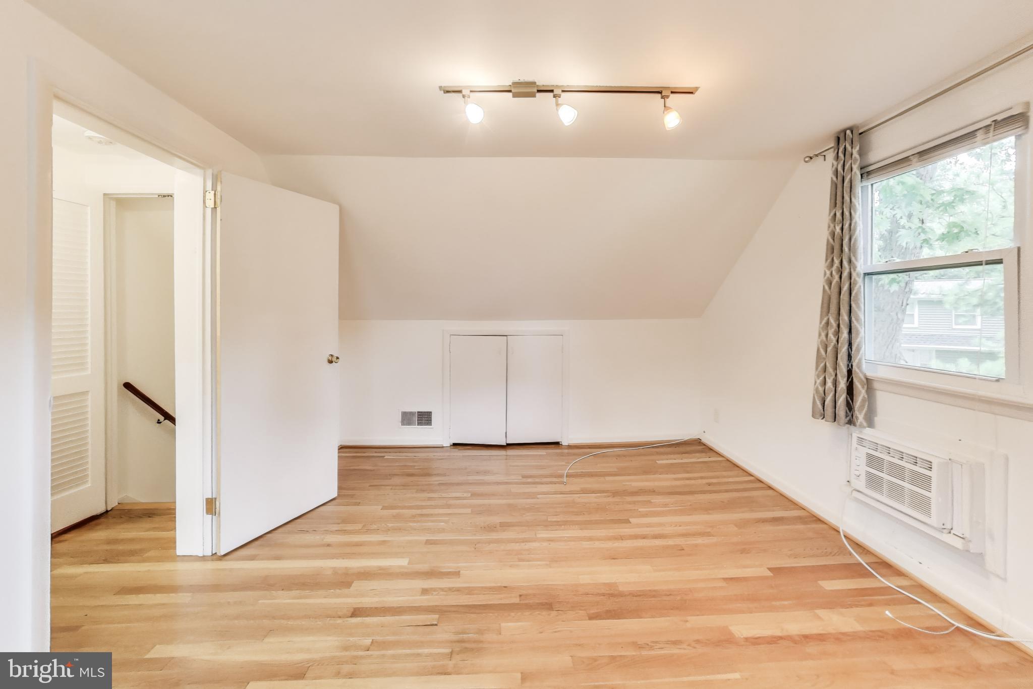 10019 Greenock Road Silver Spring, MD 20901 - Photo 20 of 39 a view of an empty room with wooden floor and a window