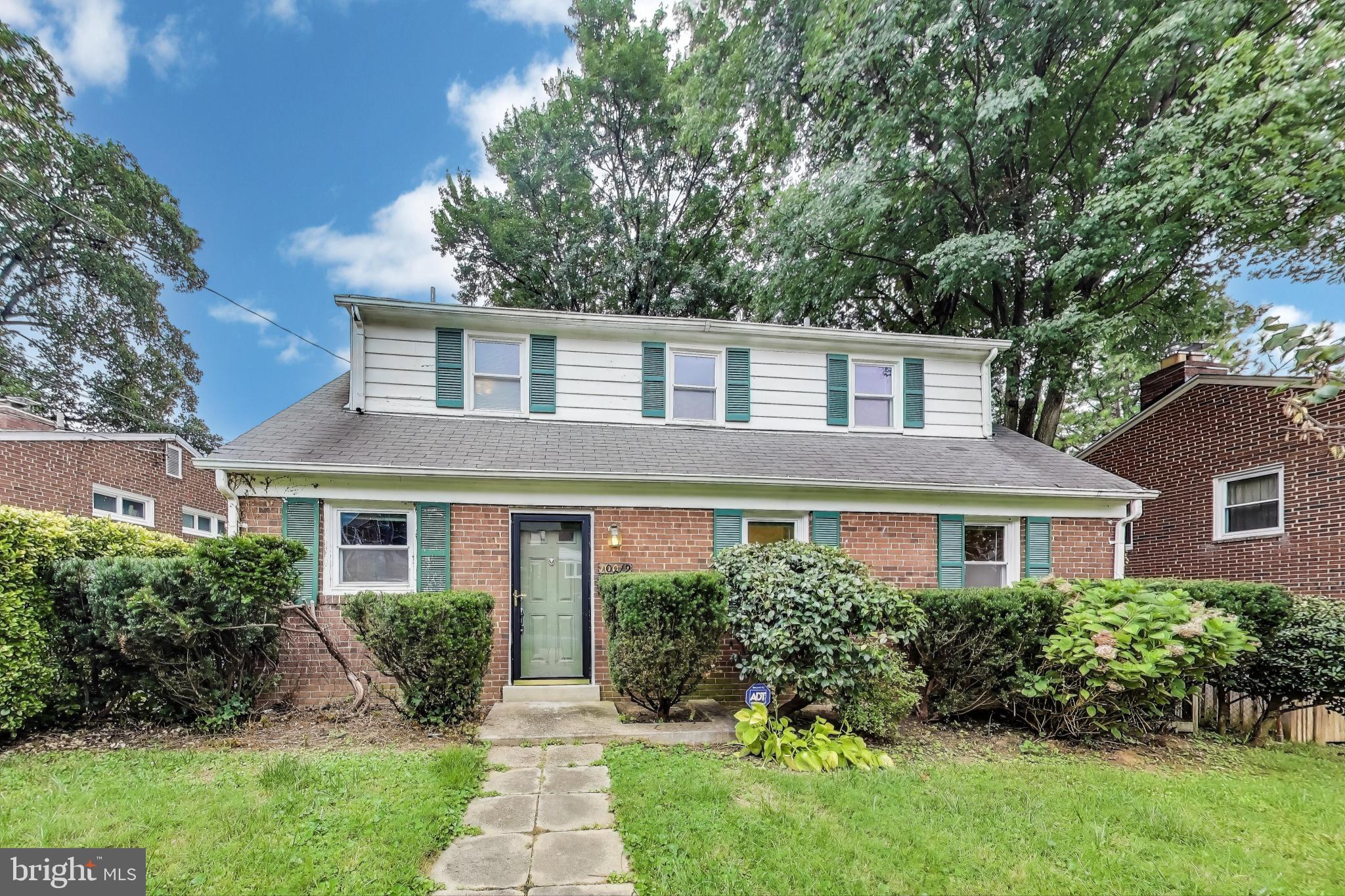 10019 Greenock Road Silver Spring, MD 20901 - Photo 2 of 39 a front view of a house with a yard and potted plants