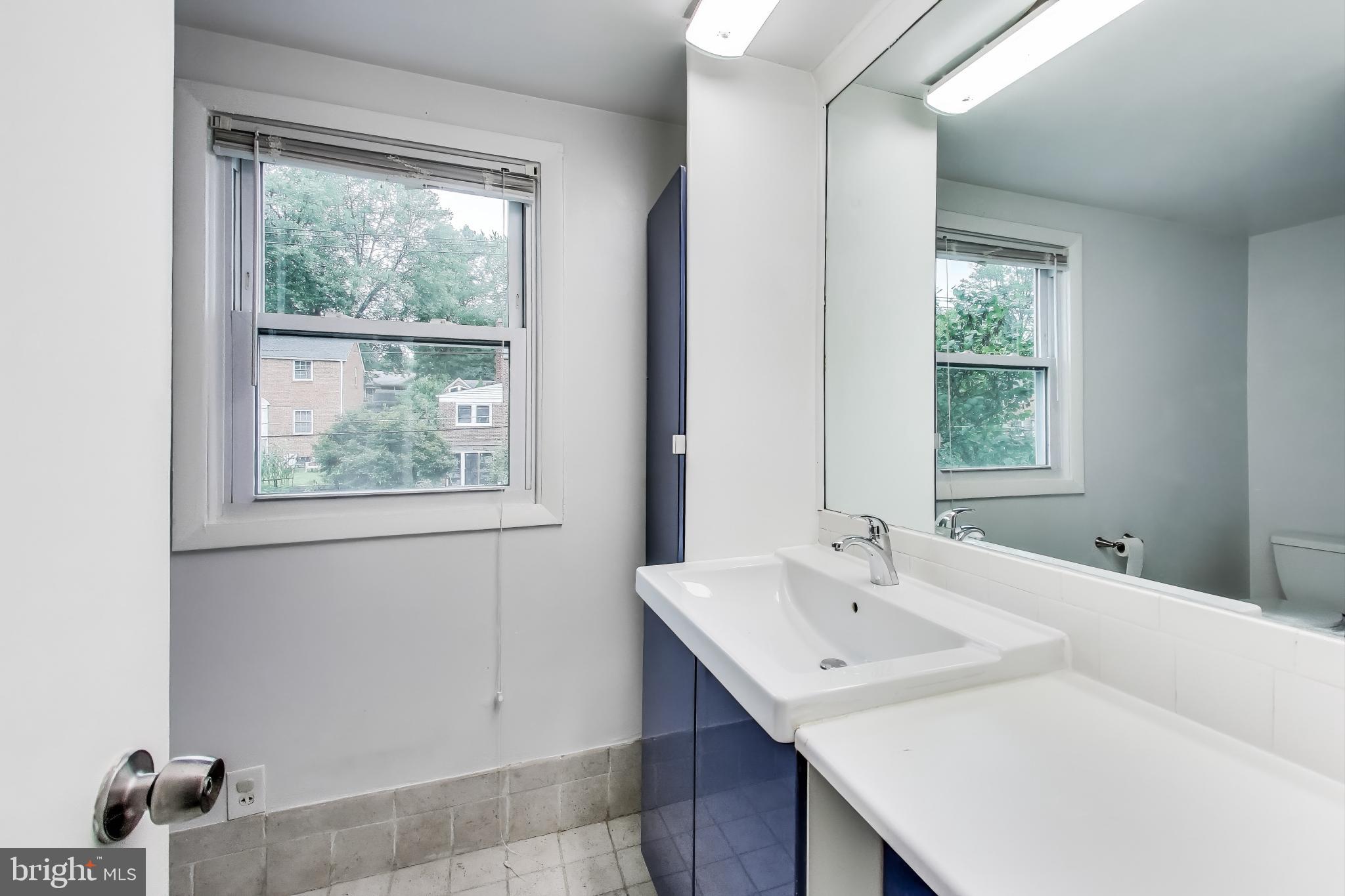 10019 Greenock Road Silver Spring, MD 20901 - Photo 23 of 39 a bathroom with a sink and a window