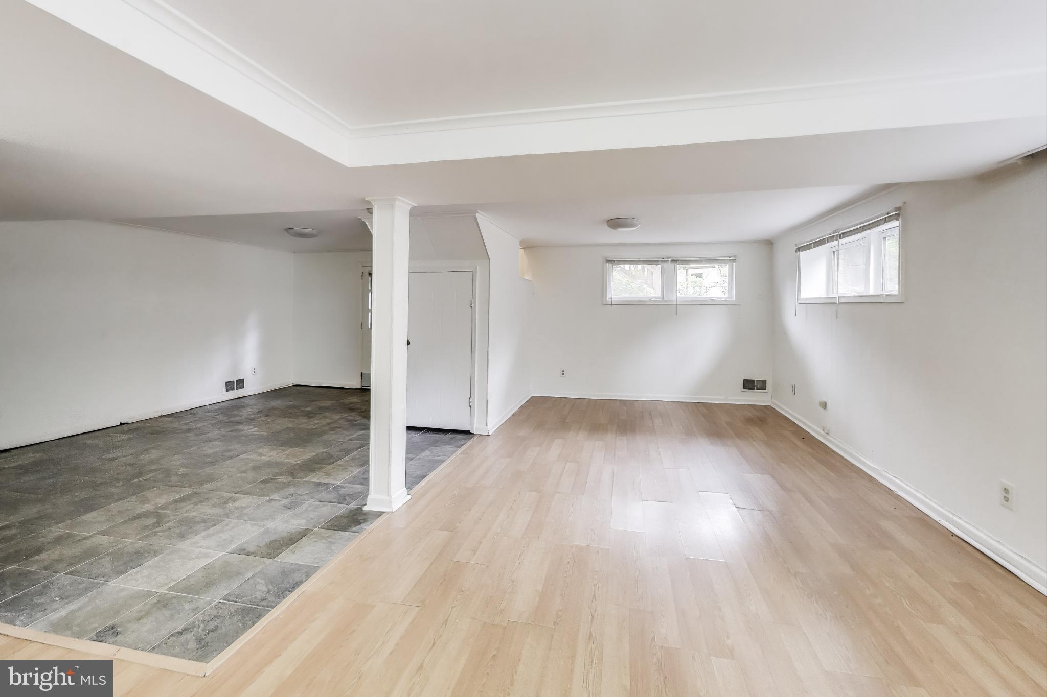 10019 Greenock Road Silver Spring, MD 20901 - Photo 25 of 39 an empty room with wooden floor and windows
