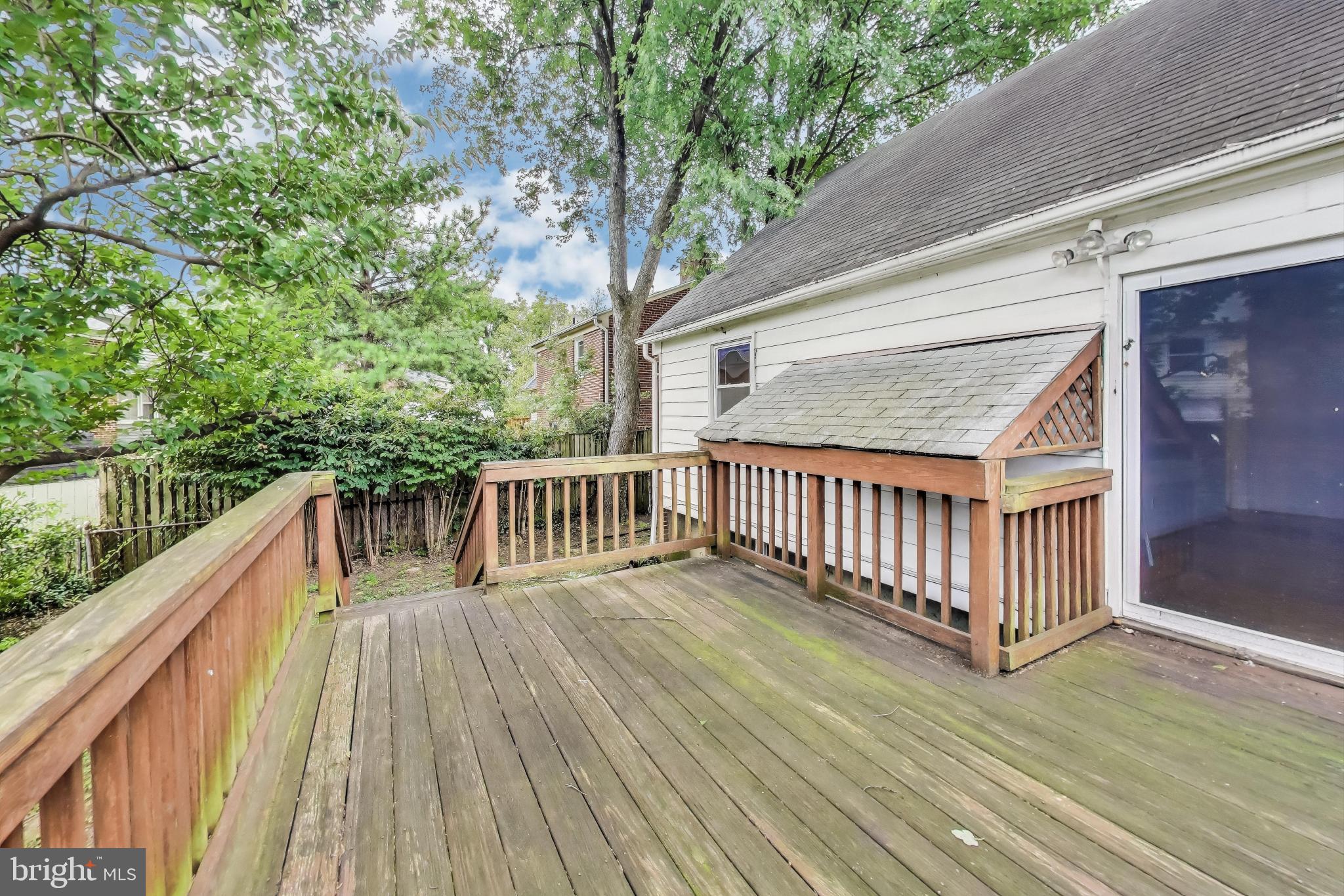10019 Greenock Road Silver Spring, MD 20901 - Photo 32 of 39 a balcony with wooden floor and trees
