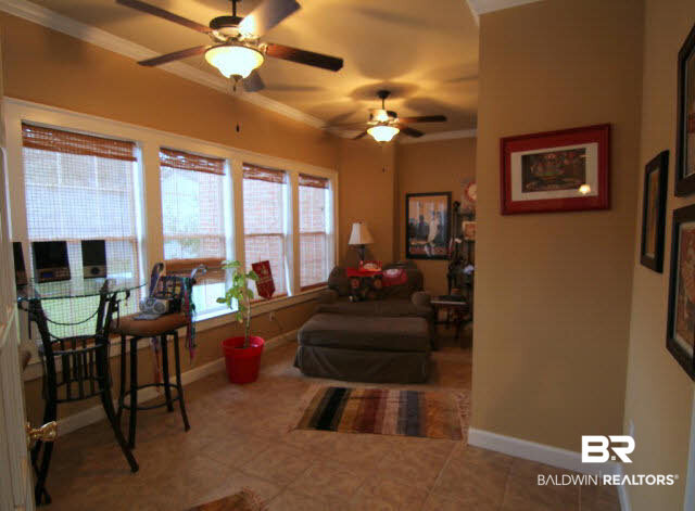 7263 Highpointe Place East Daphne, AL 36527 - Photo 13 of 22 Cozy Sun Room on the back of the home overlooks the fenced yard and offers plenty of natural light to read or craft!