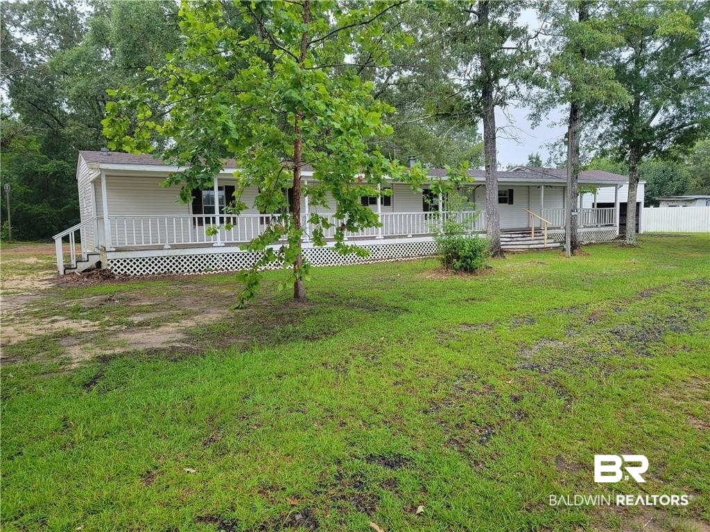 15296 Celeste Road Chunchula, AL 36521 - Photo 1 of 8 View of yard featuring a porch