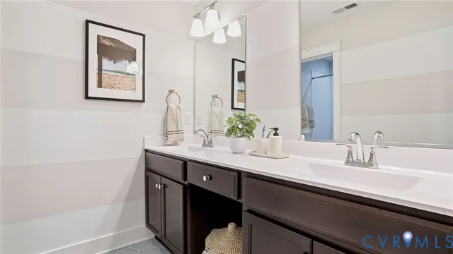 a bathroom with a double vanity sink and a mirror