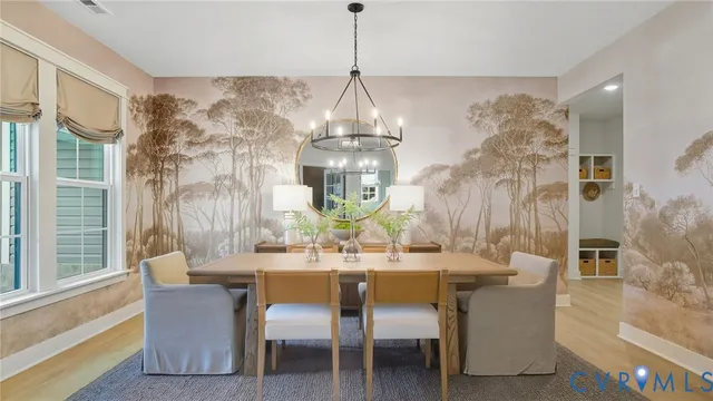 a dining room with furniture a chandelier and window