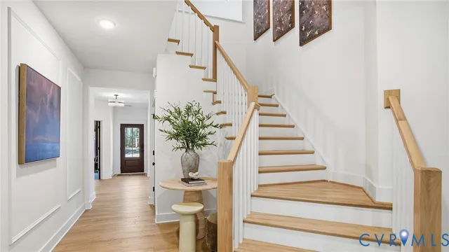 a view of entryway and hall with wooden floor