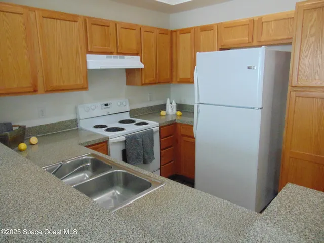 a kitchen with stainless steel appliances a refrigerator sink and cabinets