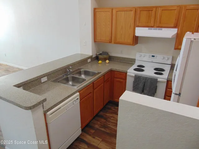 a kitchen that has a sink and a stove in it