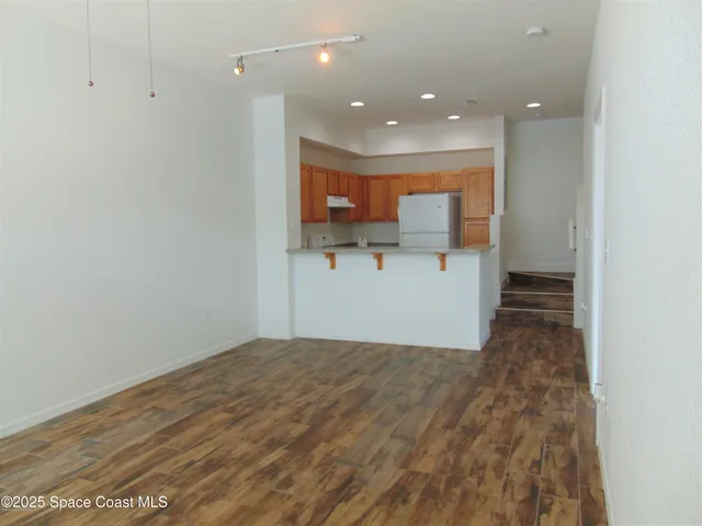 a view of a kitchen with a sink and cabinets