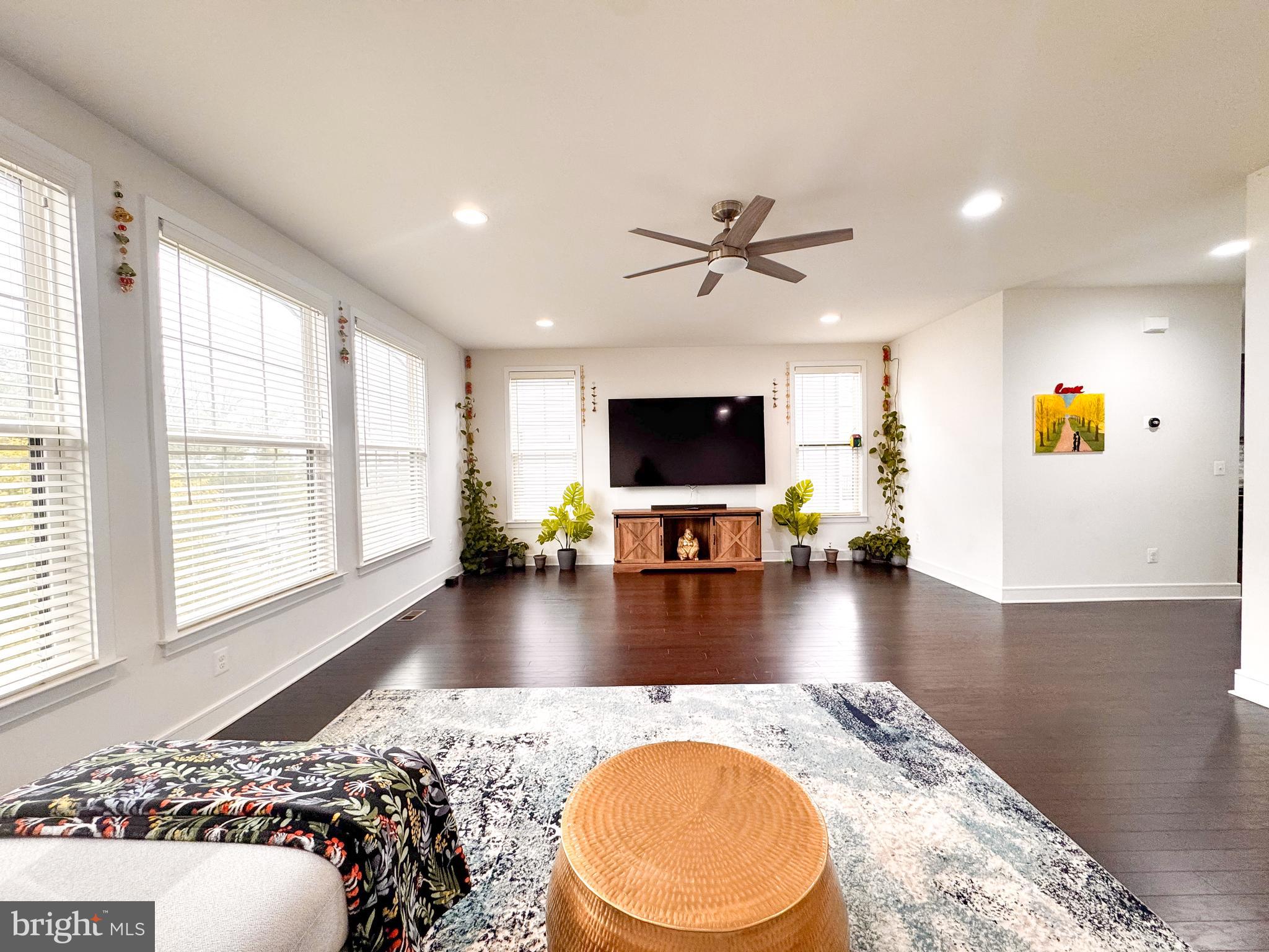 25419 Reed Orchard Terrace Chantilly, VA 20152 - Photo 14 of 47 a view of a living room and dining room with a flat screen tv