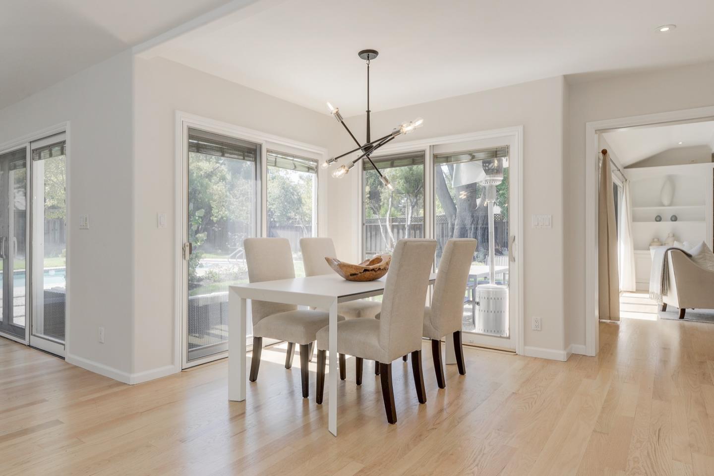 714 Arroyo Road Los Altos, CA 94024 - Photo 11 of 42 a view of a dining room with furniture window and wooden floor