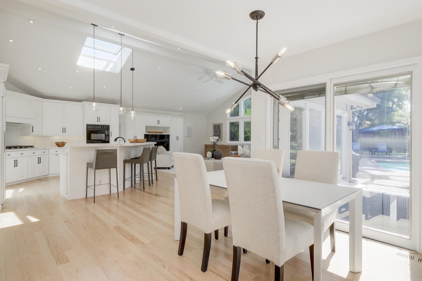 714 Arroyo Road Los Altos, CA 94024 - Photo 17 of 42 a view of a dining room and livingroom with furniture wooden floor a chandelier