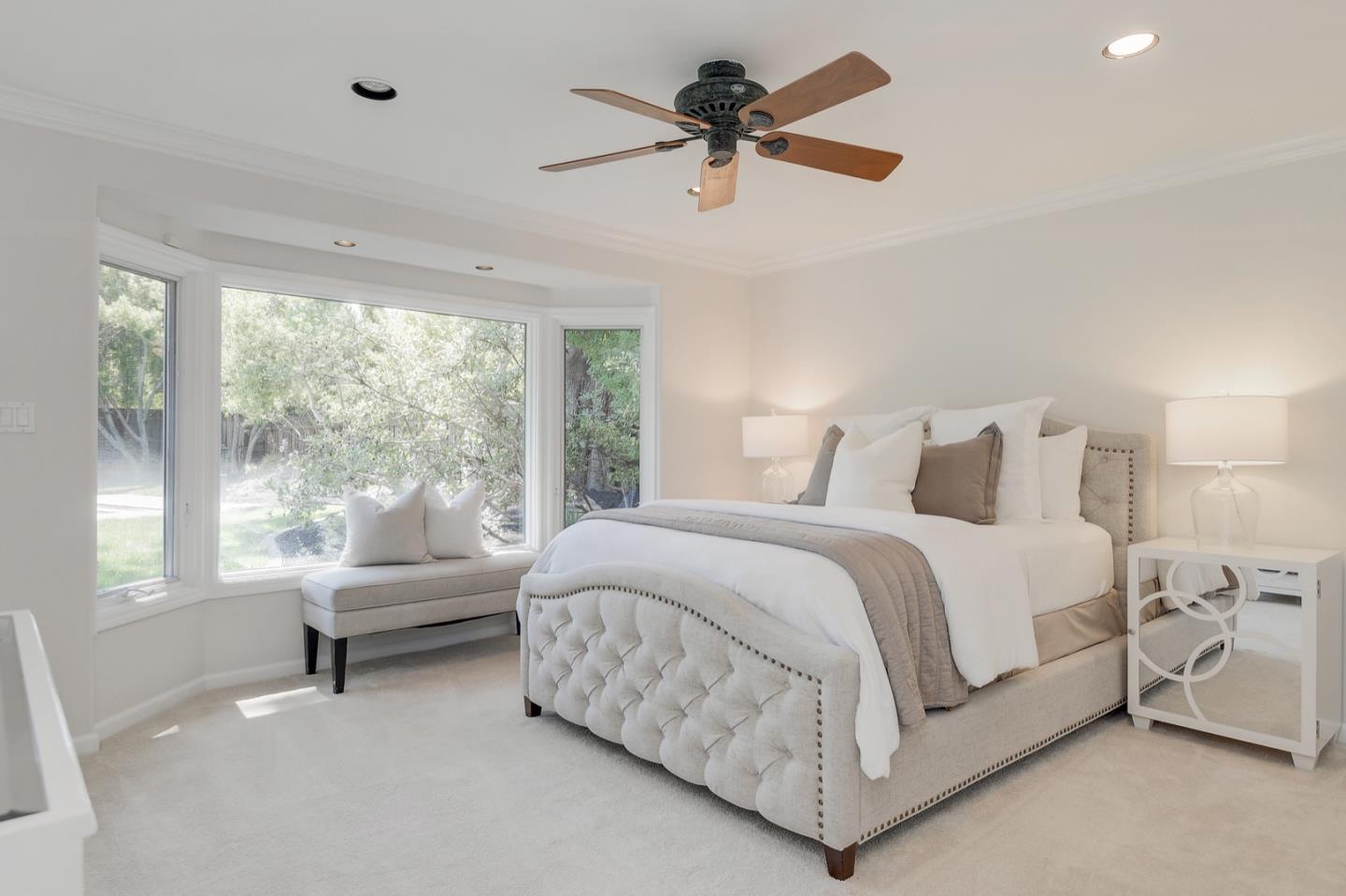 714 Arroyo Road Los Altos, CA 94024 - Photo 26 of 42 a bedroom with a large bed and a chandelier