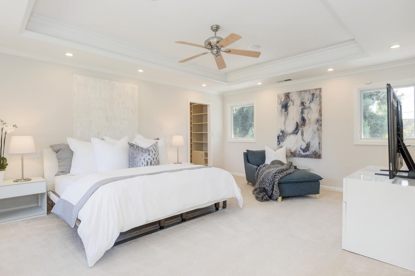 714 Arroyo Road Los Altos, CA 94024 - Photo 27 of 42 a spacious bedroom with a bed and ceiling fan