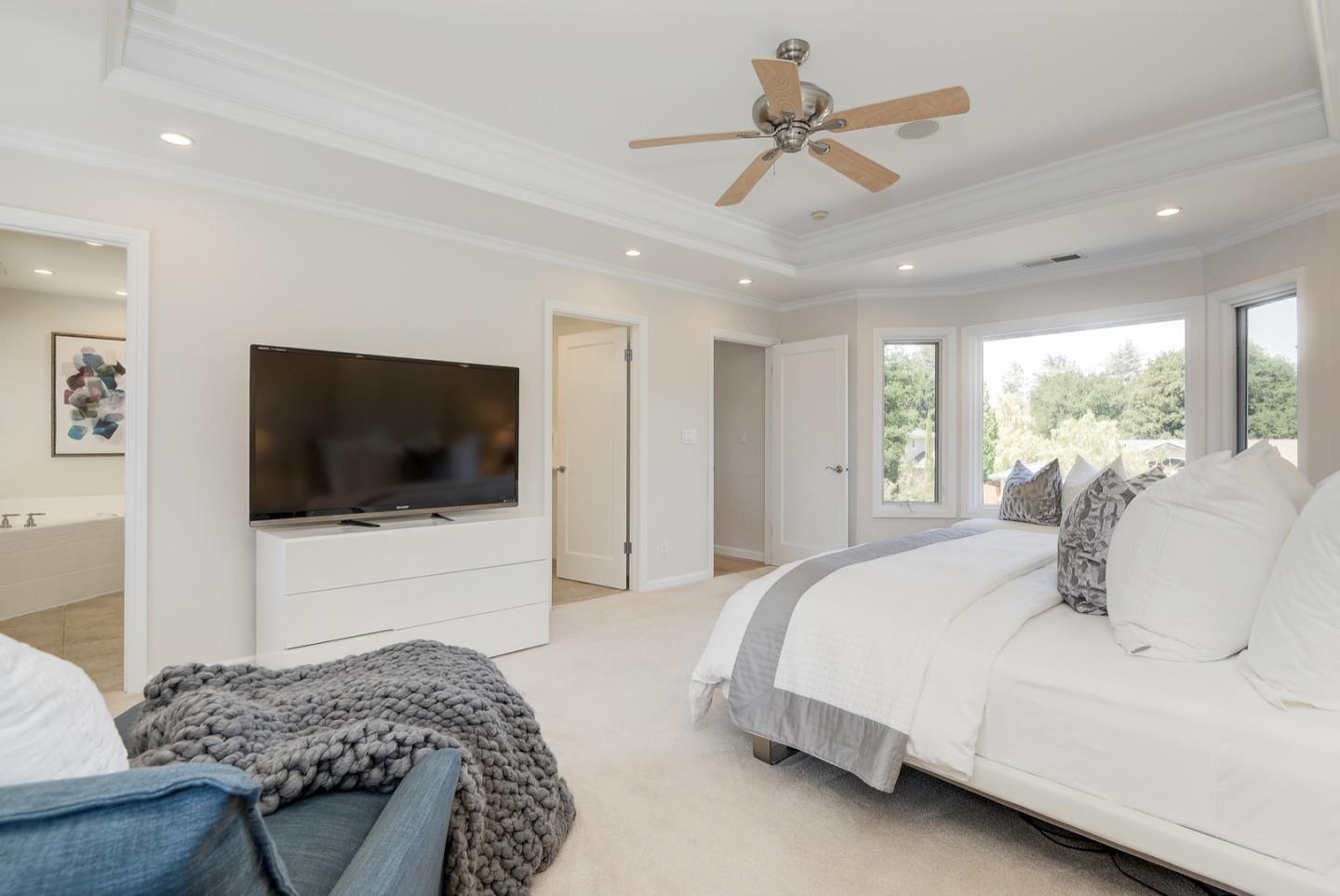 714 Arroyo Road Los Altos, CA 94024 - Photo 28 of 42 a bedroom with a large bed and a flat screen tv