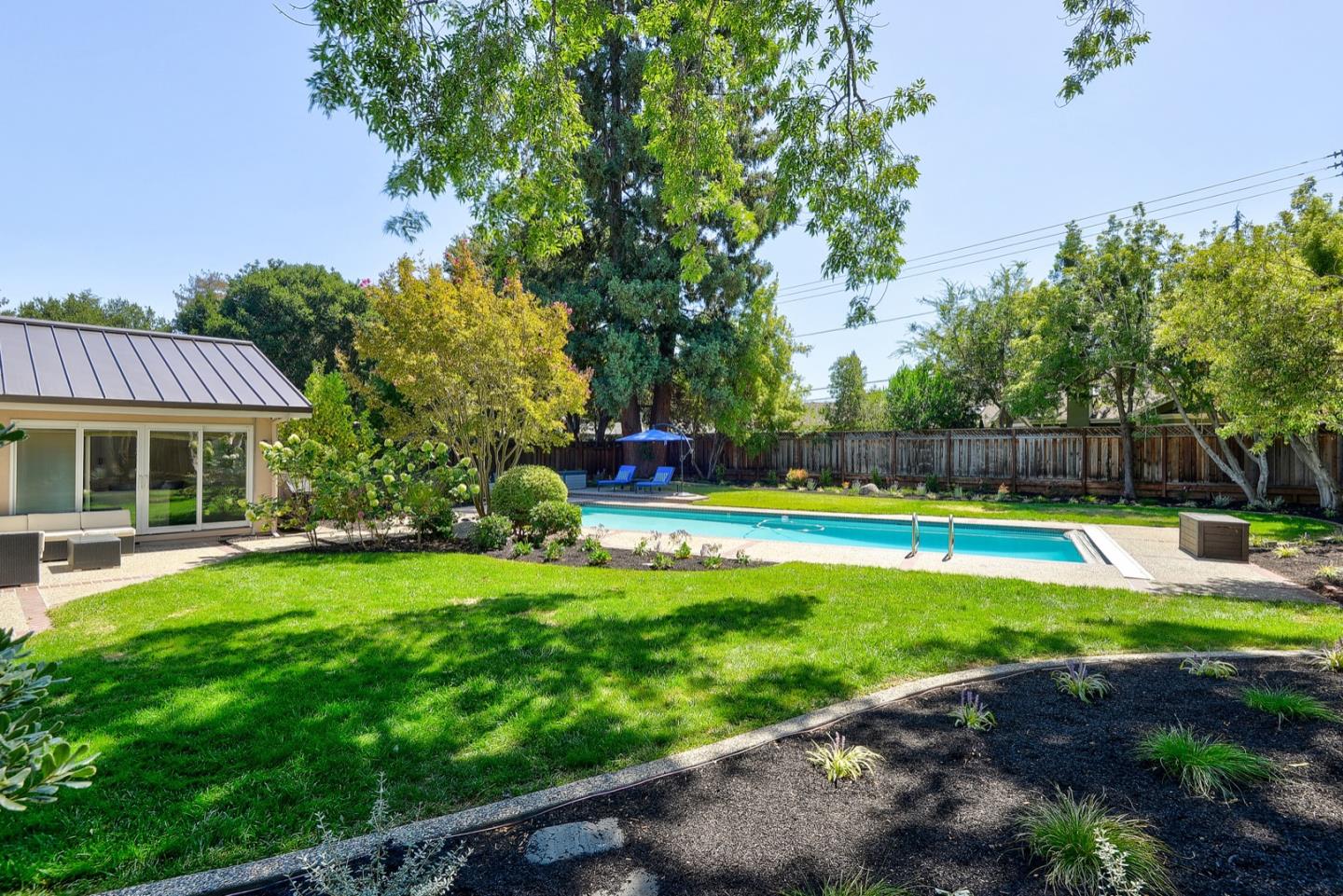 714 Arroyo Road Los Altos, CA 94024 - Photo 37 of 42 a view of a house with swimming pool and yard with green space