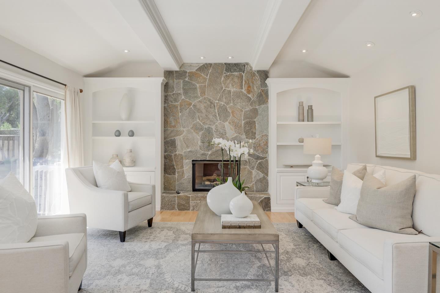 714 Arroyo Road Los Altos, CA 94024 - Photo 5 of 42 a living room with furniture a fireplace and a chandelier