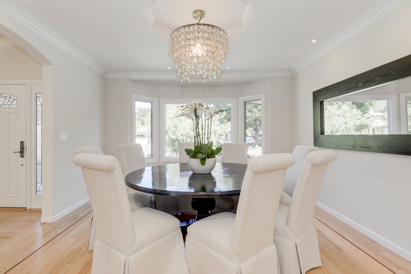 714 Arroyo Road Los Altos, CA 94024 - Photo 8 of 42 a view of a dining room with furniture wooden floor and a chandelier