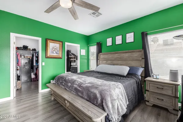 a bedroom with a bed mirror and a window