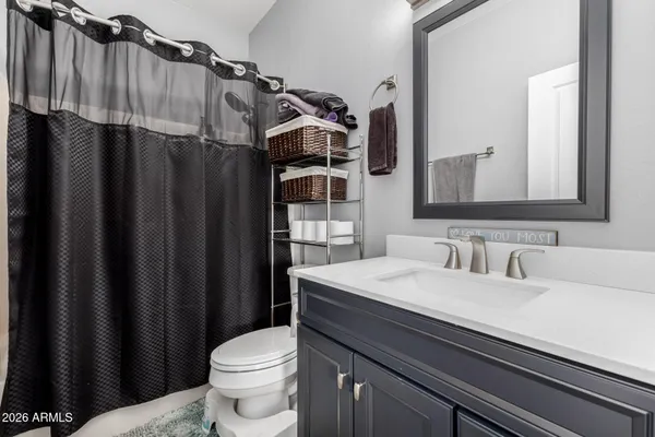 a bedroom with a bed next to a window