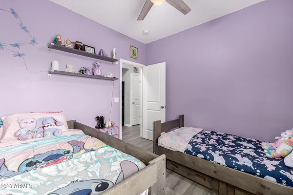 a bathroom with a granite countertop sink a toilet and a mirror