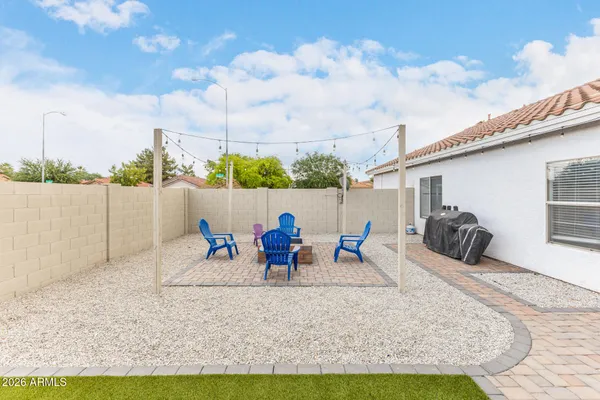 a view of a backyard with sitting area