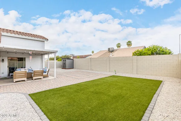 a front view of a house with swimming pool having outdoor seating