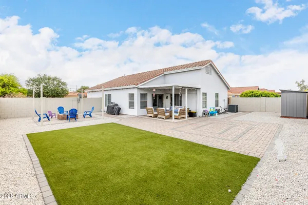 a view of backyard with barbeque grill wooden fence